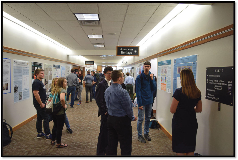 Fig.2. Undergraduate Student Participants Interact with Faculty and Other Students in the Poster Gallery Hallway During an Open House Preceding an Awards Ceremony